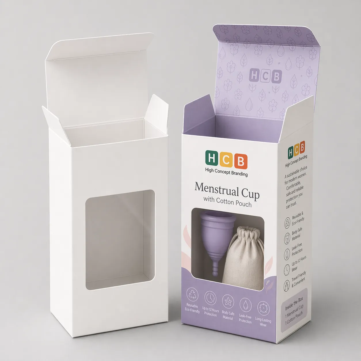 Two boxes with circular window cutouts, one plain and one printed with pink floral patterns. class=